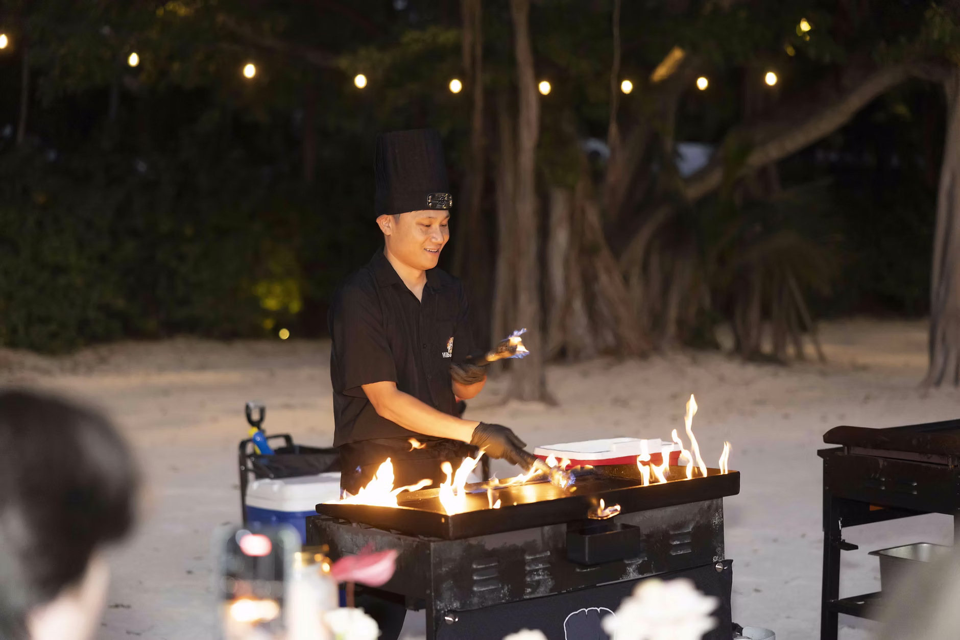 Hibachi chef cooking on an outdoor grill at a private celebration